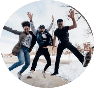 three young people jumping on the street